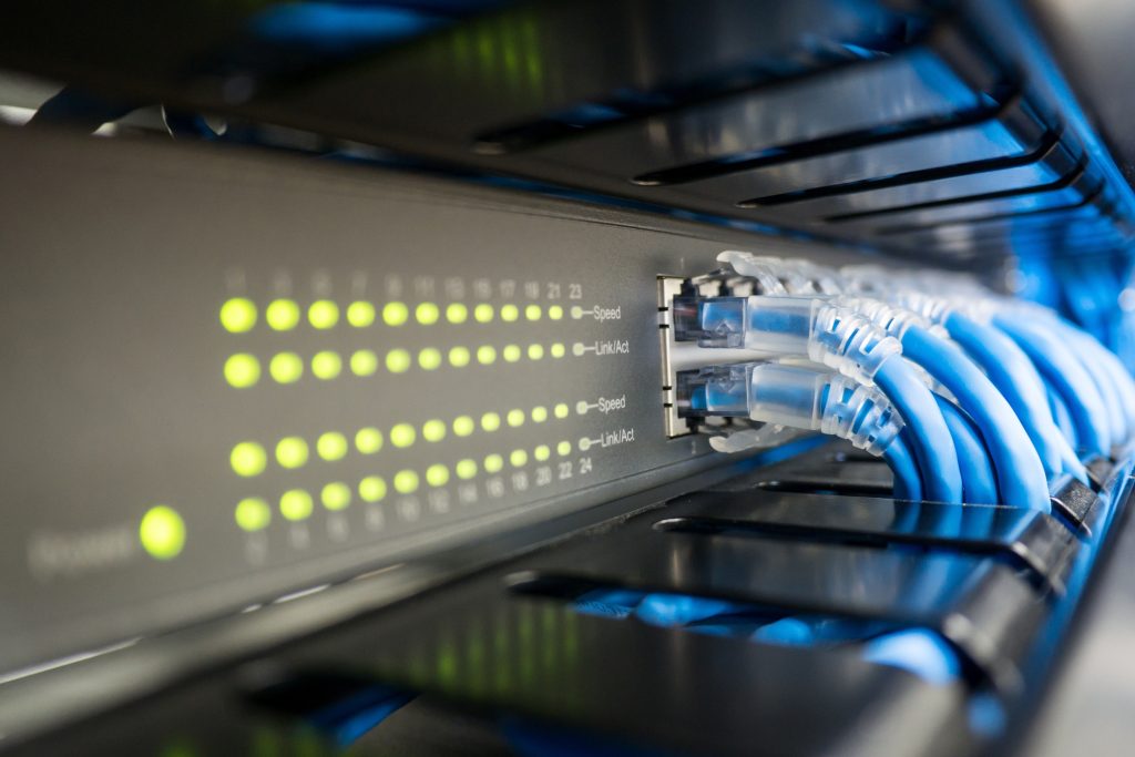 Network,Switch,And,Ethernet,Cable,In,Rack,Cabinet.,Network,Connection